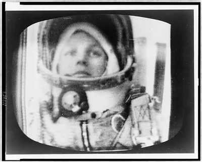[Photograph of television screen with Valentina Nikolaeva-Tereshkova, head-and-shoulders portrait, in astronaut outfit during her fifth orbit]