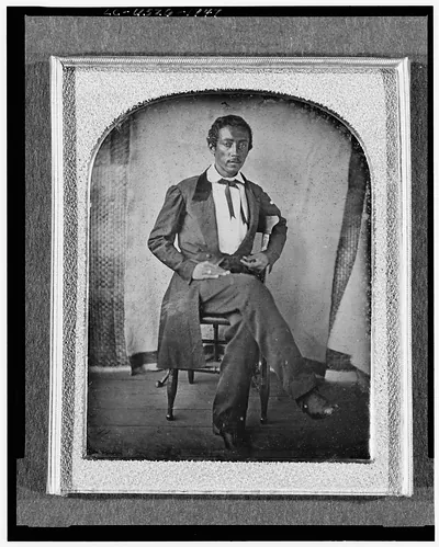 [R. McGill, full-length portrait, seated in chair, facing front, with textile screen in background]