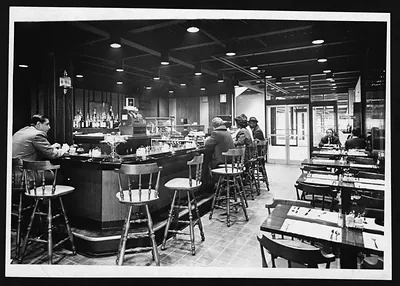 Cocktail bar and restaurant interior with diners at the counter