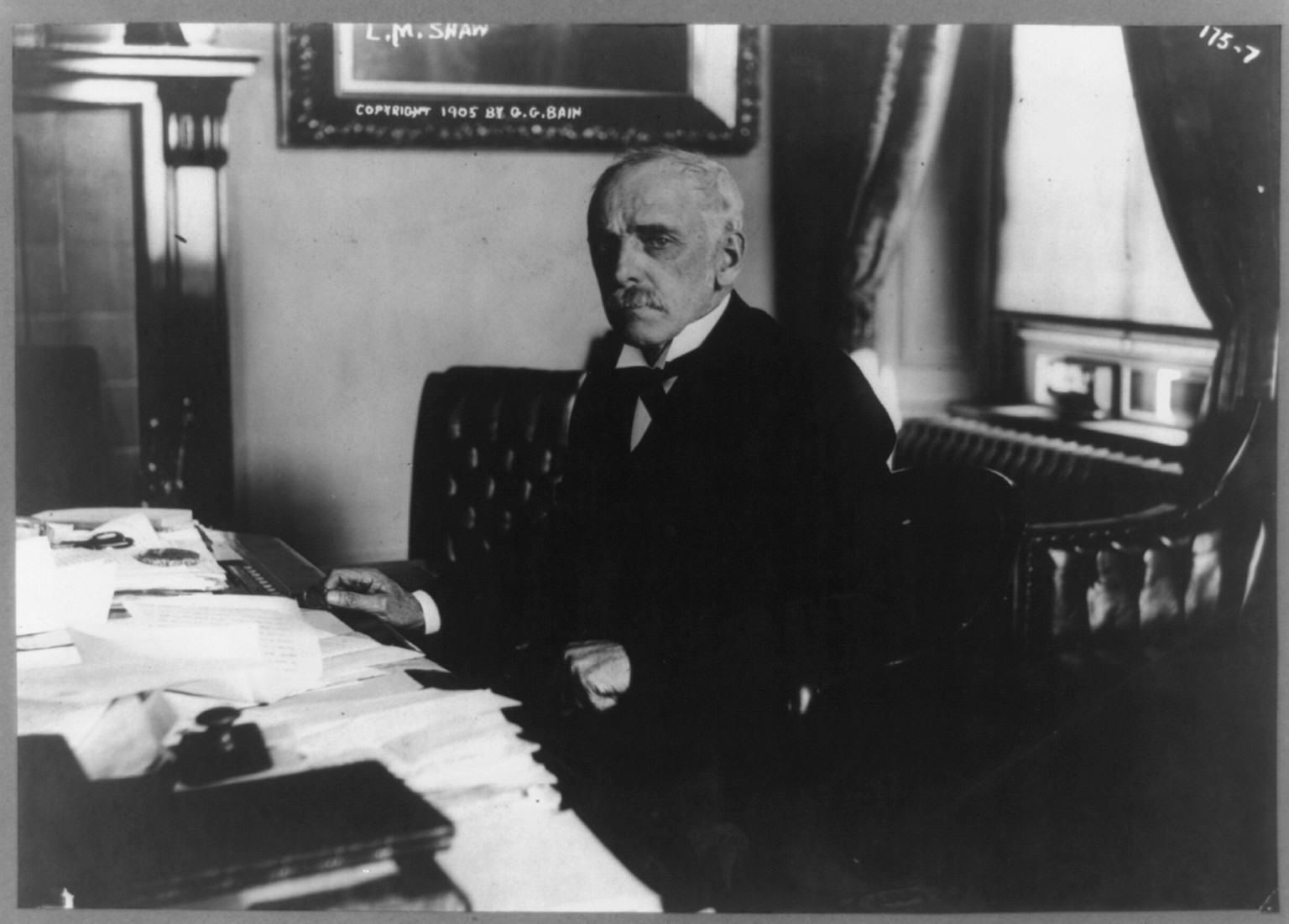 [Leslie M. Shaw, half-length portrait, seated at desk, facing left], c1905. — historic photograph