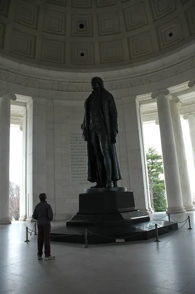 Bronze statue inside a domed memorial rotunda with columns