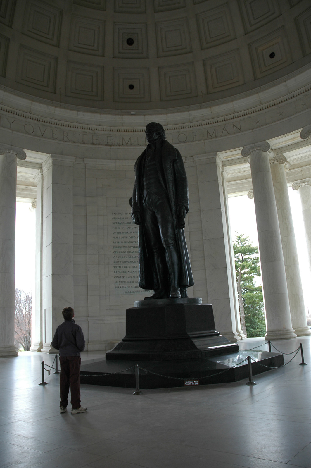 Bronze statue inside a domed memorial rotunda with columns — historic image