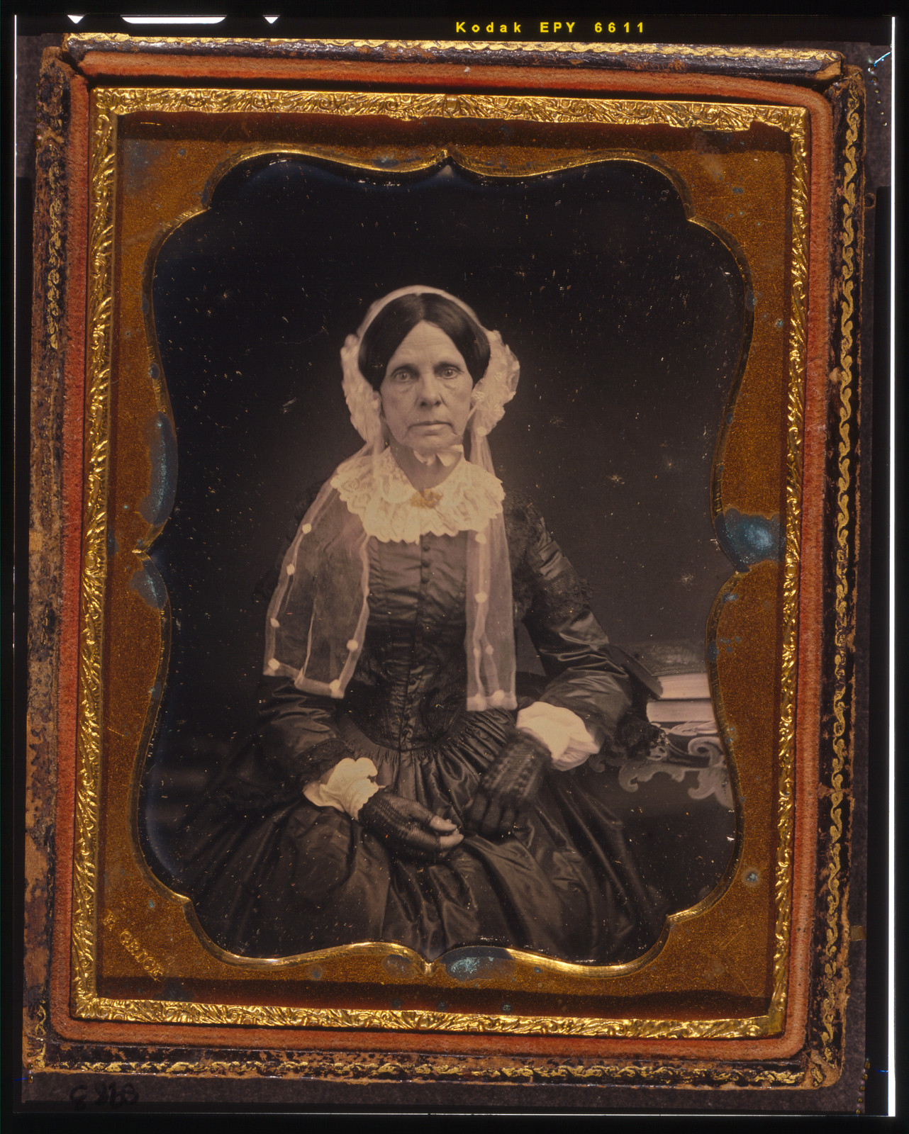 [Unidentified woman, three-quarters length portrait, seated with left arm resting on table with tablecloth and book], [ca. 1855] — historic photograph
