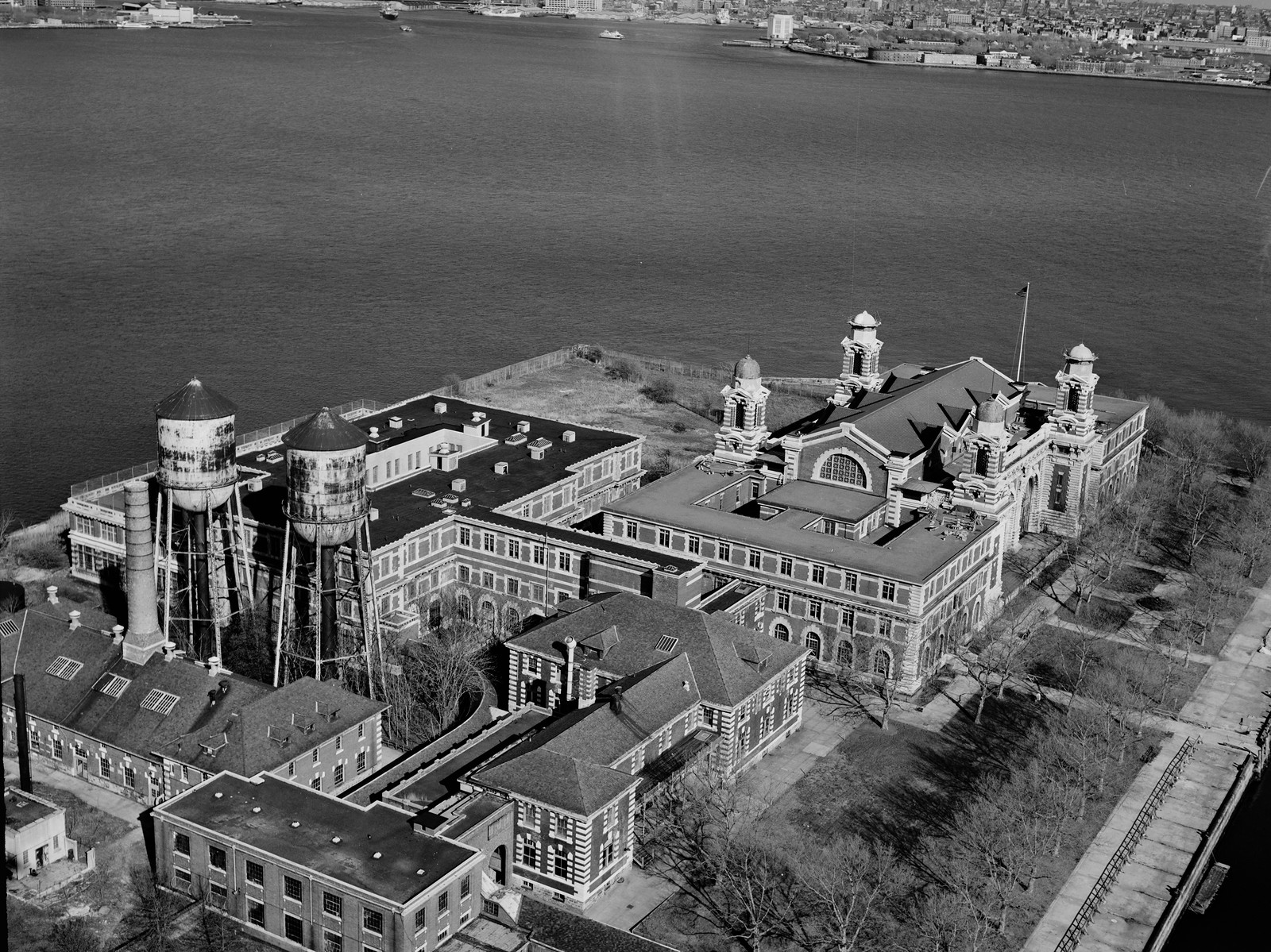 Aerial black-and-white view of Ellis Island immigration buildings — historic image
