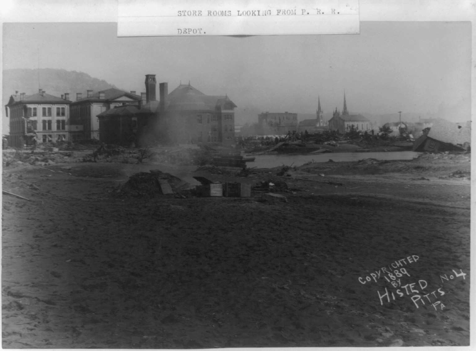 Cambria Iron Company's office an store rooms looking from P.R.R. depot, Johnstown Flood, May 31st, 1889, c1889. — historic photograph