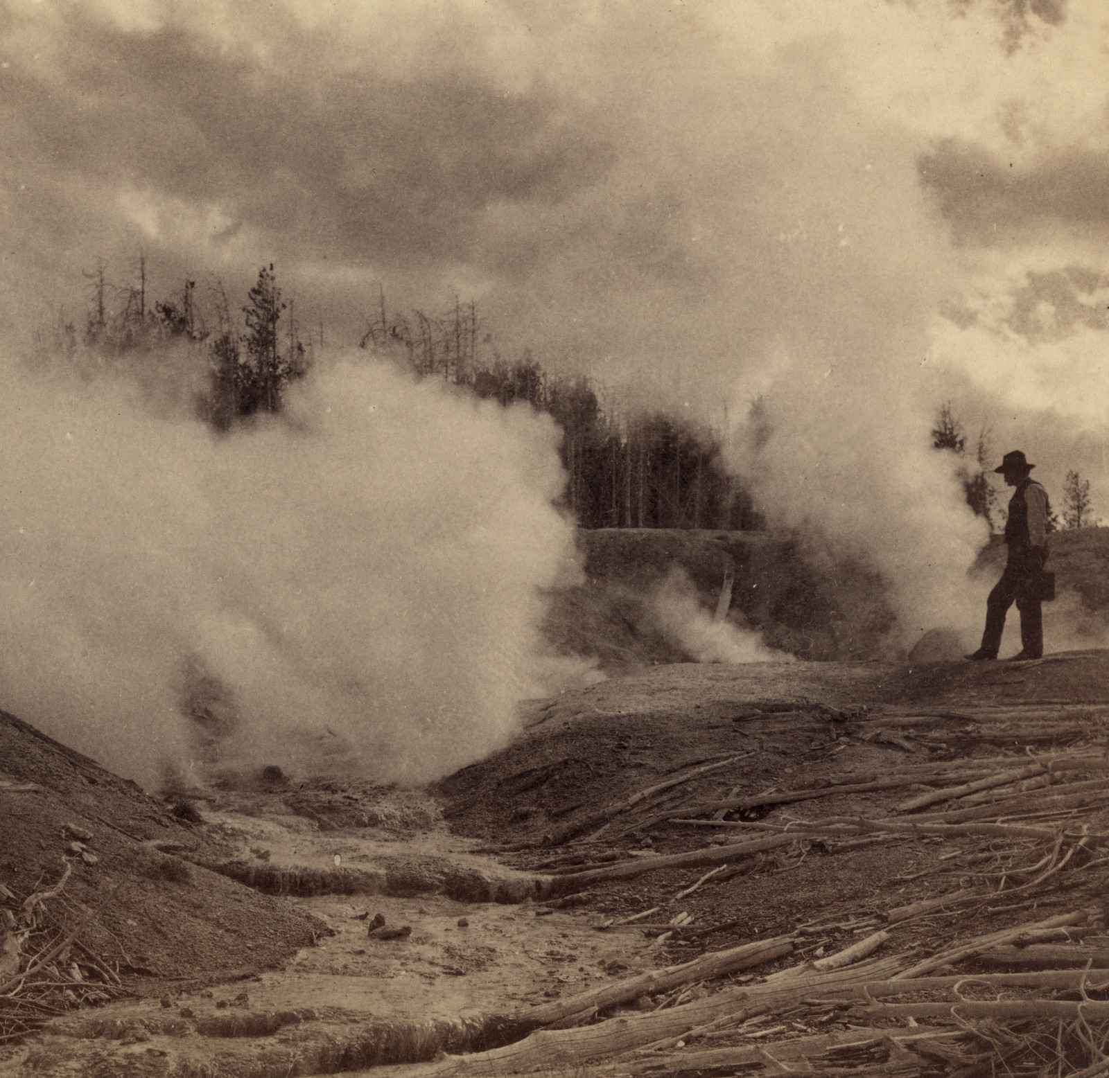 Steam rising from hot springs, man in hat standing — historic image