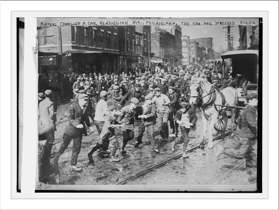 Rioters charging horse-drawn car, later wrecking it on Kensington Ave., Philadelphia, 2/21/10. — historic photograph
