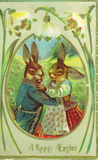 Vintage Easter postcard with dressed rabbits in an oval frame