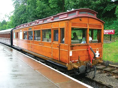 Wooden railway carriage at a station platform, max speed 75 mph