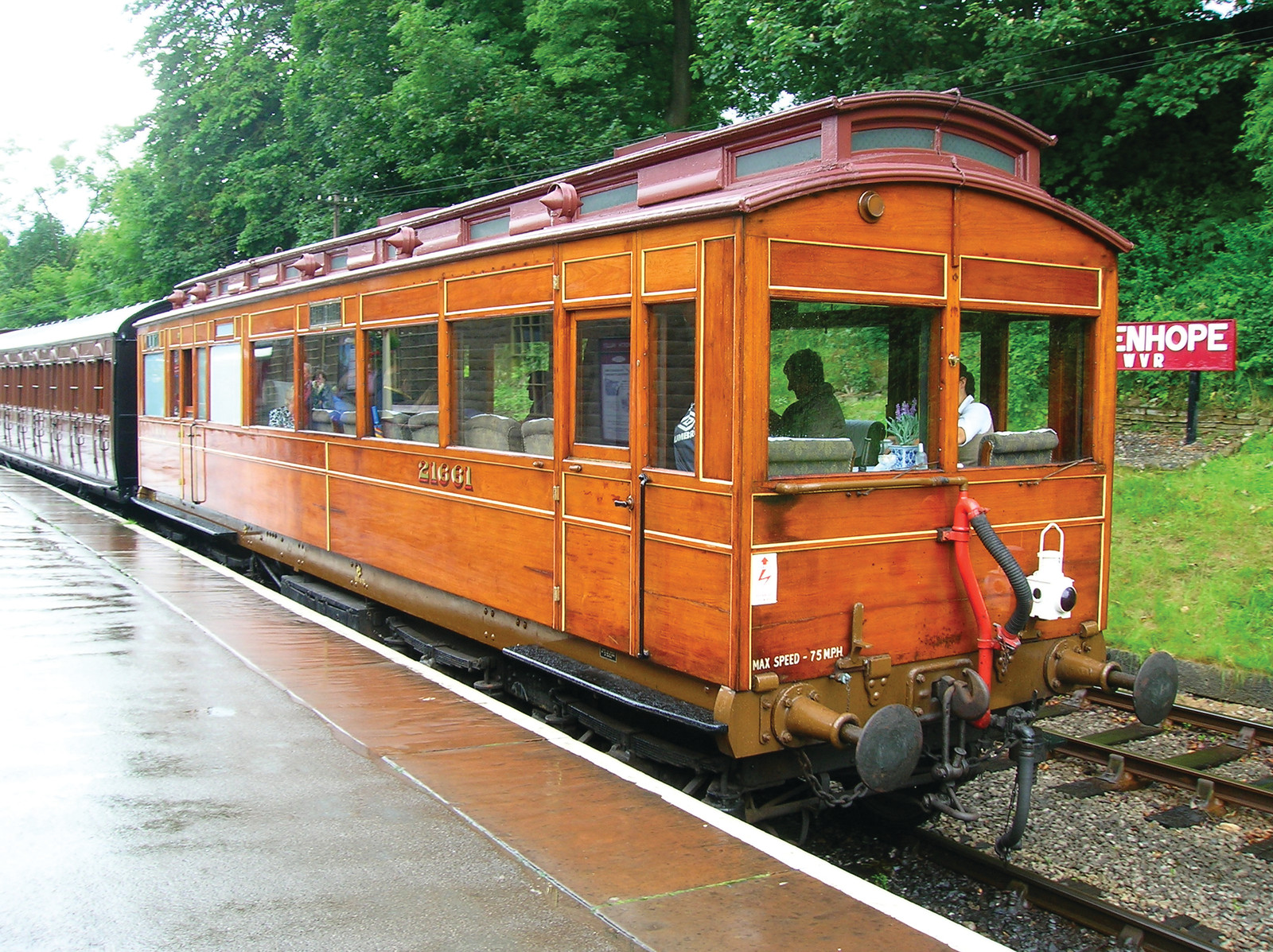 Wooden railway carriage at a station platform, max speed 75 mph — historic image