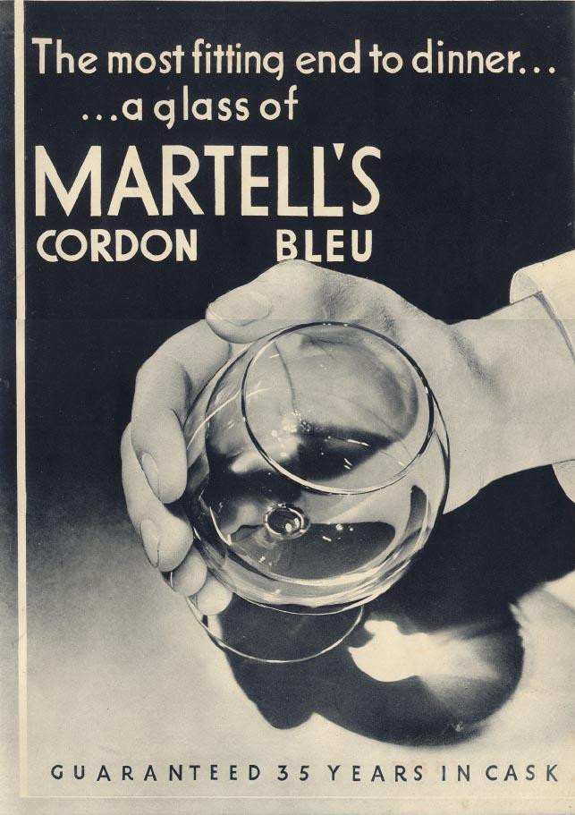 Martell's Cordon Bleu cognac advertisement with hand holding glass — historic image
