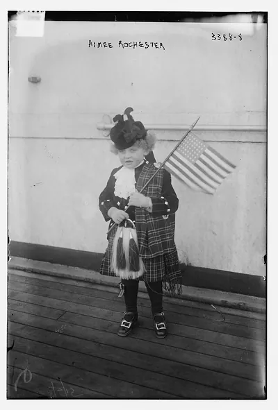 Aimee Rochester in Scots outfit w. American Flag as child