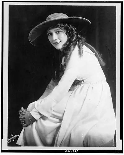 [Mary Pickford, three-quarter length portrait, seated, facing left]