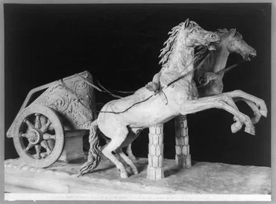[Sculpture of two rearing horses pulling chariot, in a Roman museum]