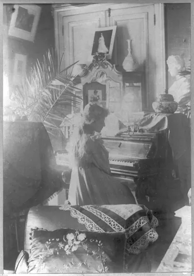 [Amelie Rives, half-length portrait, seated at piano, right profile]