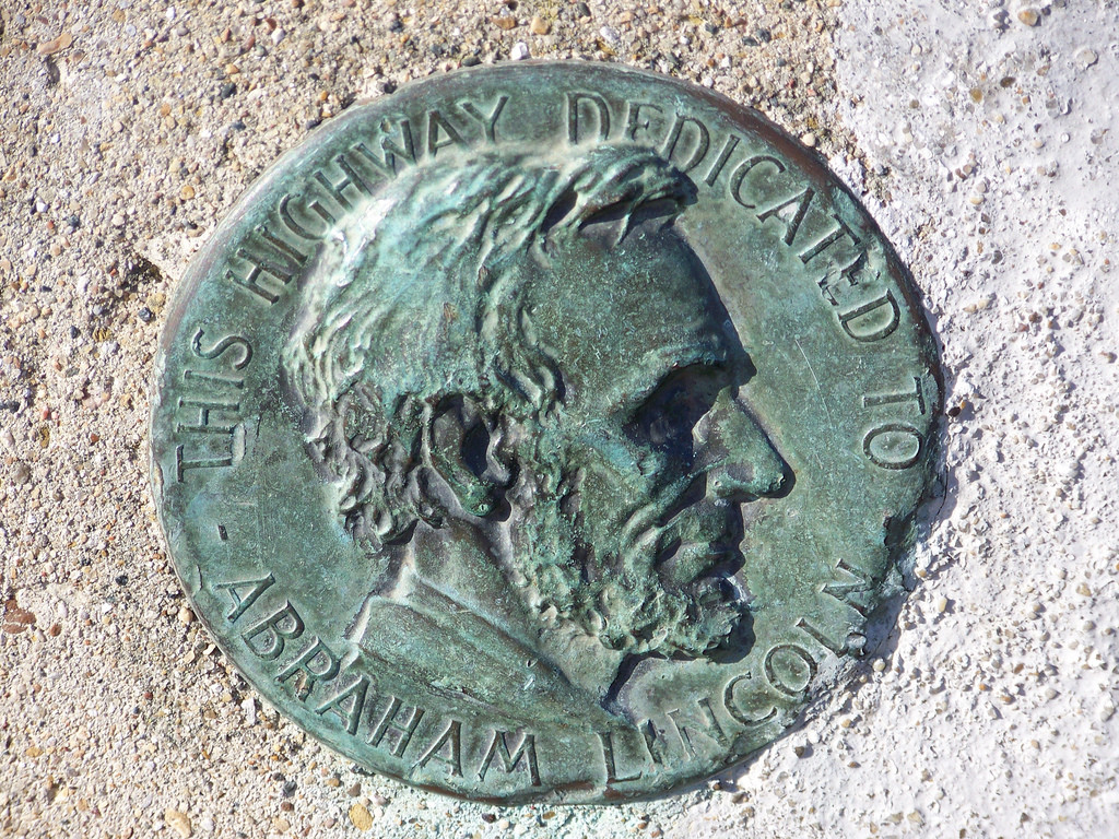 Bronze medallion of Abraham Lincoln on highway dedication marker — historic image