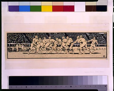 Football players in a tackle scrum before a packed stadium crowd