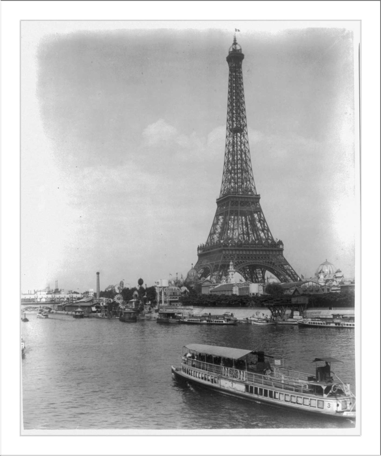 [Eiffel Tower and exposition buildings on the Champ de Mars, as seen from the River Seine, Paris Exposition, 1889], [1889] — historic print