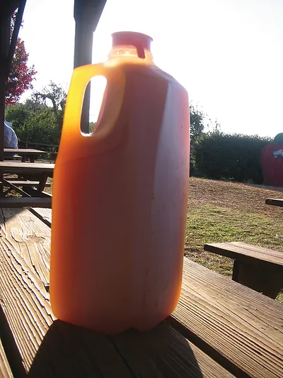 Orange plastic jug on a picnic table