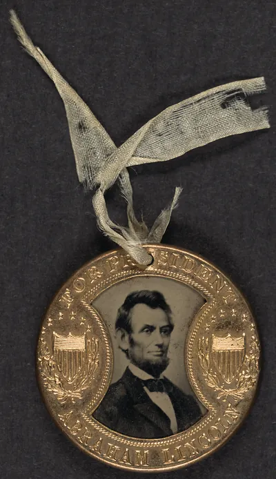 Brass campaign badge reading For President Abraham Lincoln, with portrait