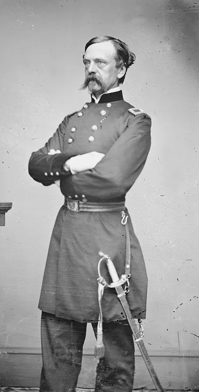 Union officer in uniform with crossed arms and sword