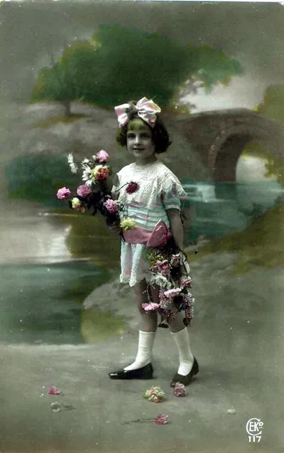 Hand-tinted postcard of a girl with flowers