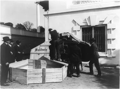 [Baldwin piano being unpacked from crate and moved into the White House(?), 1921(?)]