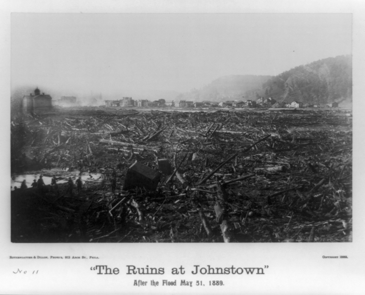 The ruins at Johnstown, after the flood, May 31, 1889. View of the gorge and ruined city from the P.R.R. bridge / Rothengatter & Dillon, photo's., Phila., c1889. — historic photograph
