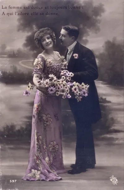 Hand-colored postcard of a couple with flowers and French verse