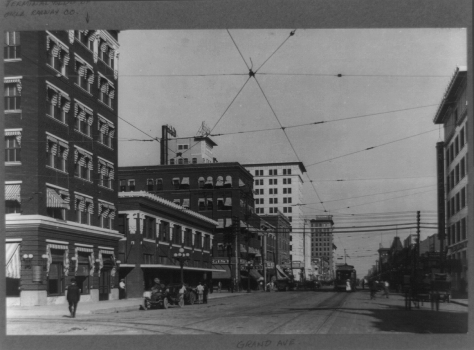 [Grand Avenue business district, Oklahoma City, Oklahoma with Terminal Building of Oklahoma Railway Co. on left], [between 1915 and 1920] — historic photograph