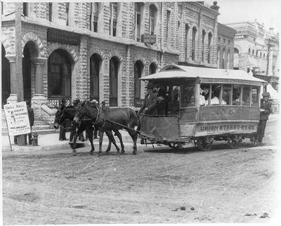 [Horse-drawn trolley on street in Winfield, Kansas]