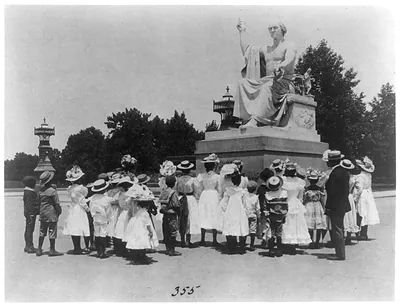 [African American school children facing the Horatio Greenough statue of George Washington at the U.S. Capitol]