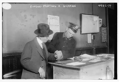 NYC police fingerprinting a German, 1917, Photo by Bain News Service / Bain News Service