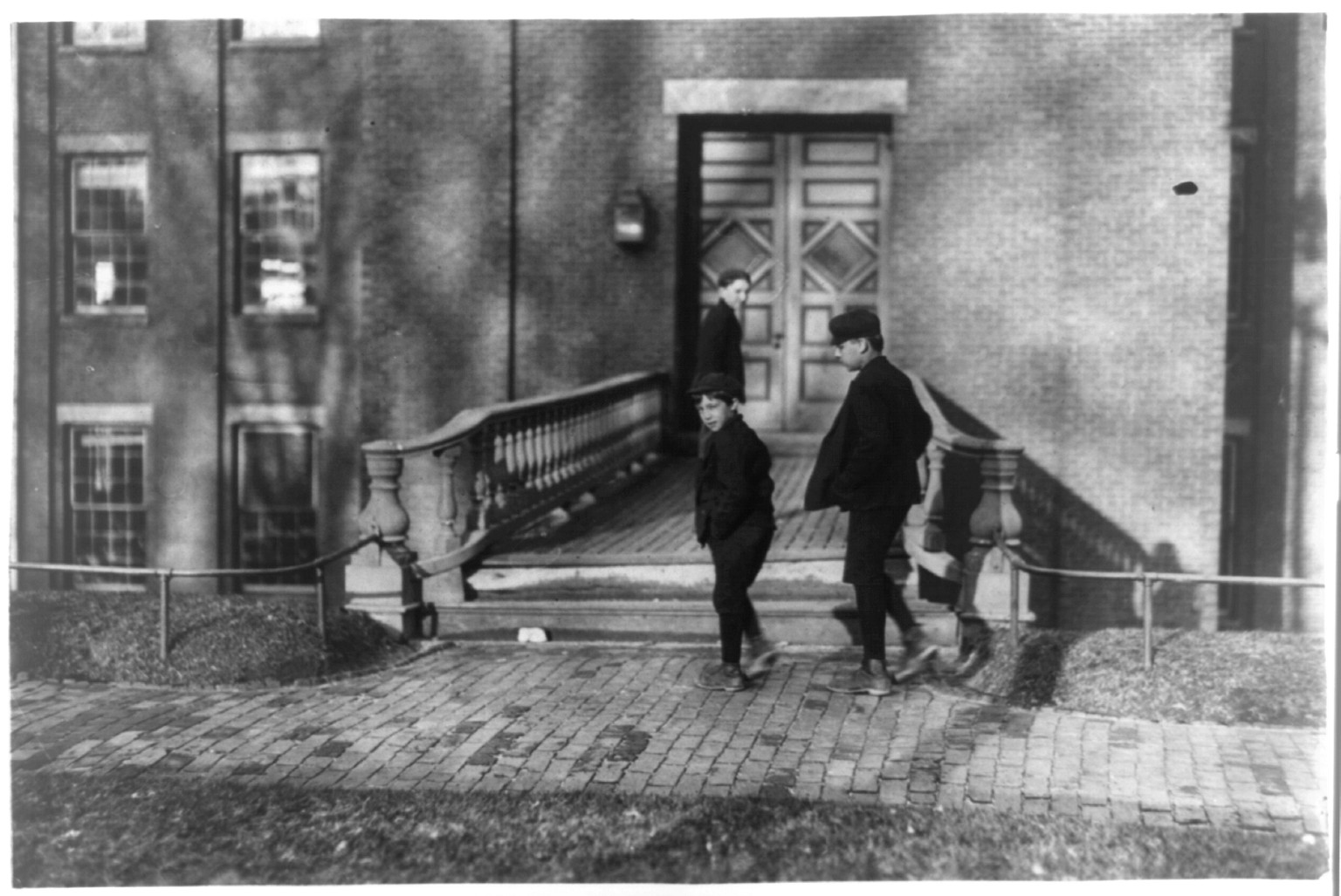 5:30 A.M. Boys going to work Hill Mfg. Co., Lewiston, Me. I saw them at work inside. Location: Lewiston, Maine., 1909 April. — historic photograph