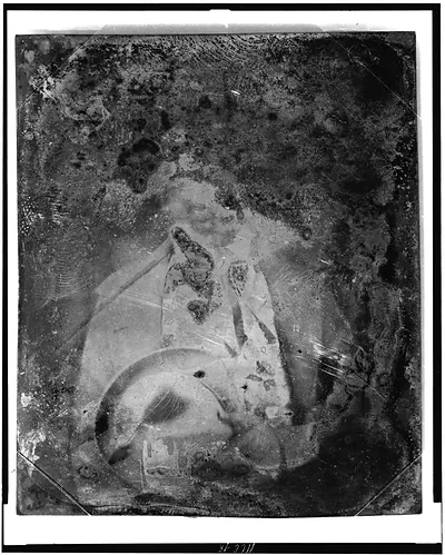 Deteriorated daguerreotype portrait of a seated figure