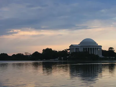 Jefferson Memorial at dusk across calm water