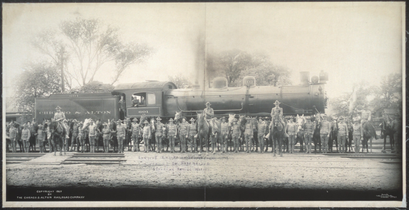 Cavalry troops and horses before Chicago & Alton locomotive 601 — historic image