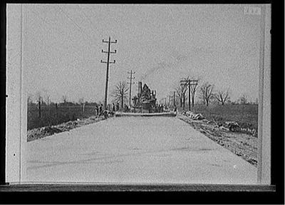 [Steamroller grading road, probably Michigan]