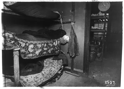 [Interiors of New York City tenements, 1905-10: dirty bedroom with 3 tiers of bunks]