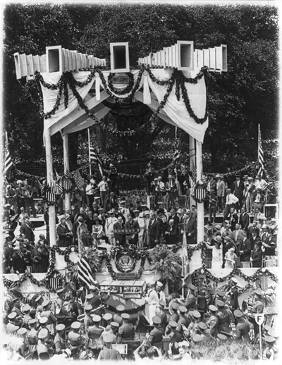 [Charles Lindbergh on podium on Washington Monument grounds during his Washington, D.C., reception - Army band in foreground]