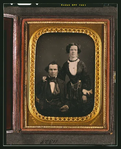 [Unidentified couple, man seated and woman standing]