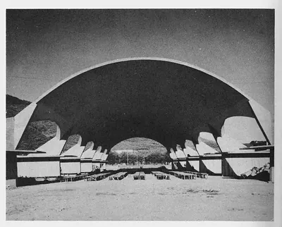 Concrete shell canopy over open-air rows of seating