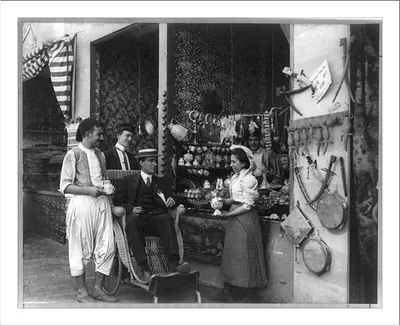 [Pan-American Exposition, Buffalo, N.Y., 1901: Man in wheeled chair at souvenir shop with 4 other persons]
