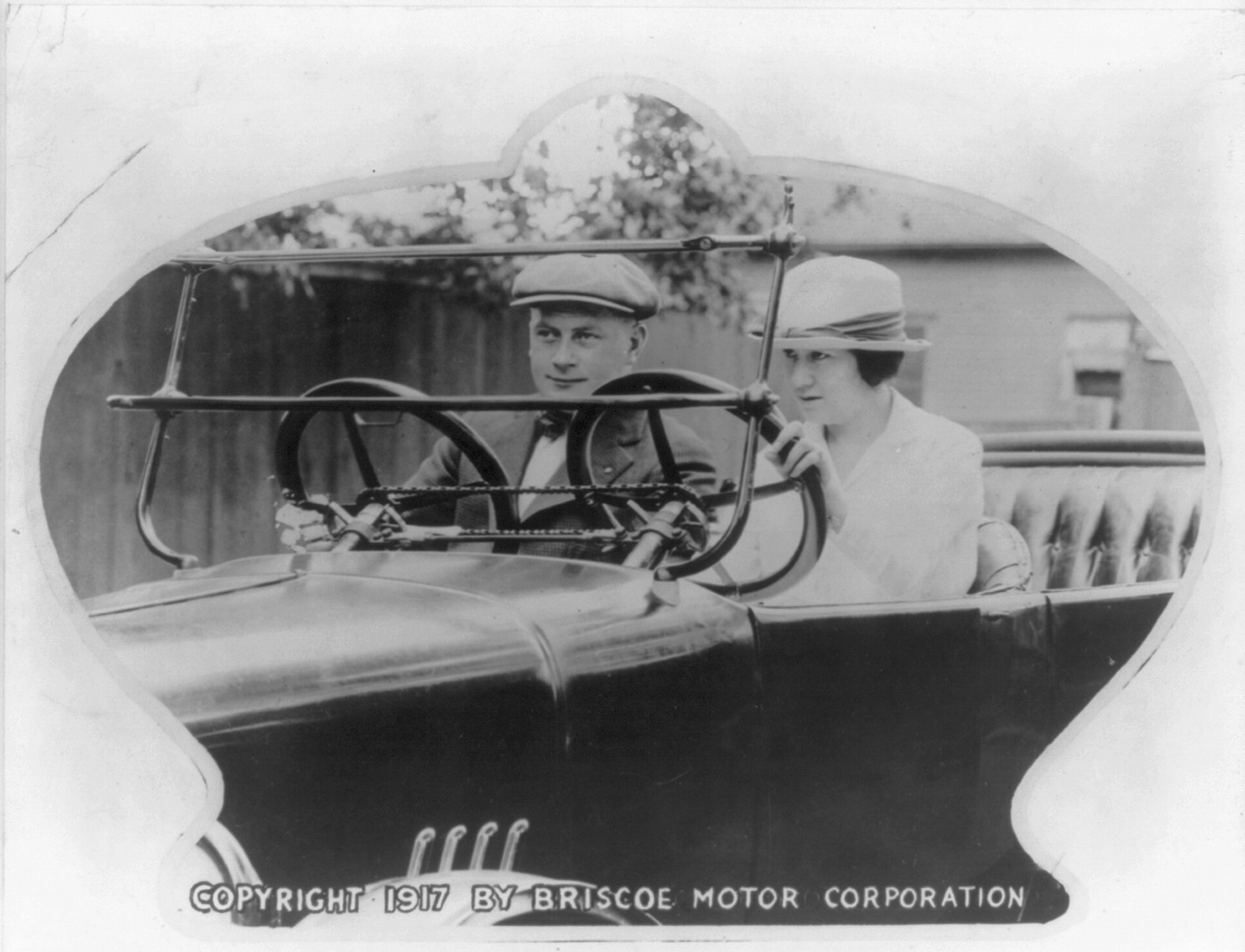 [Automobile driving instruction - student driver and instructor in roadster fitted with dual controls], c1917. — historic photograph