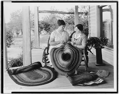 [Two women making rugs on porch]