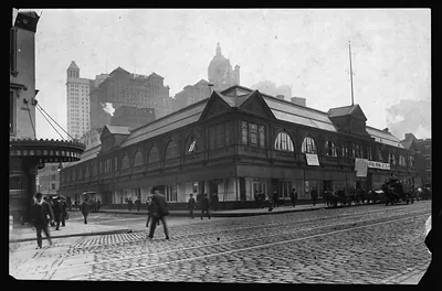Market building with arched windows on a cobbled street