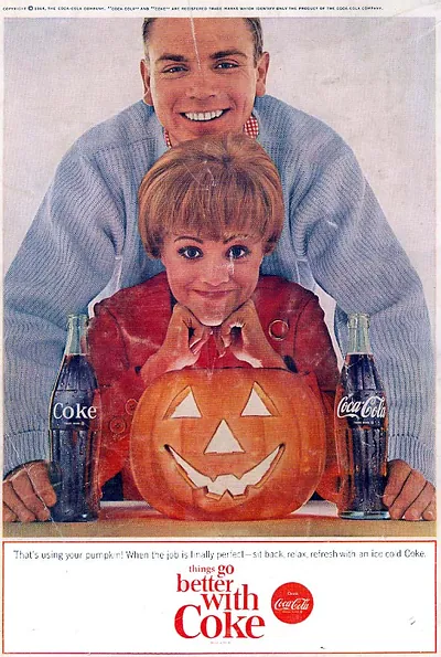 Coca-Cola advertisement with boy and carved jack-o'-lantern pumpkin