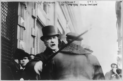 [J.P. Morgan striking photographer with cane]