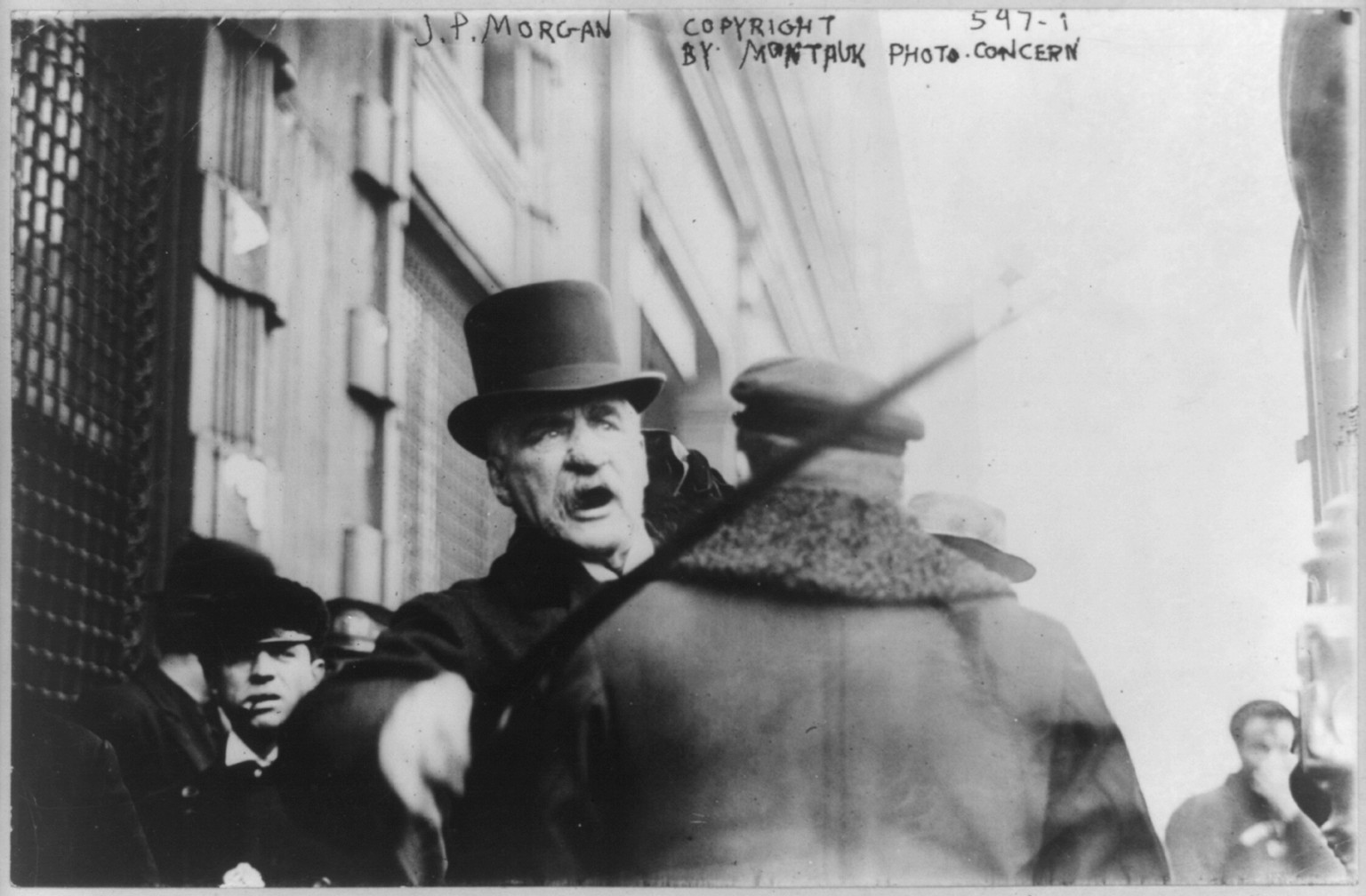 [J.P. Morgan striking photographer with cane], c1910 May 11. — historic photograph