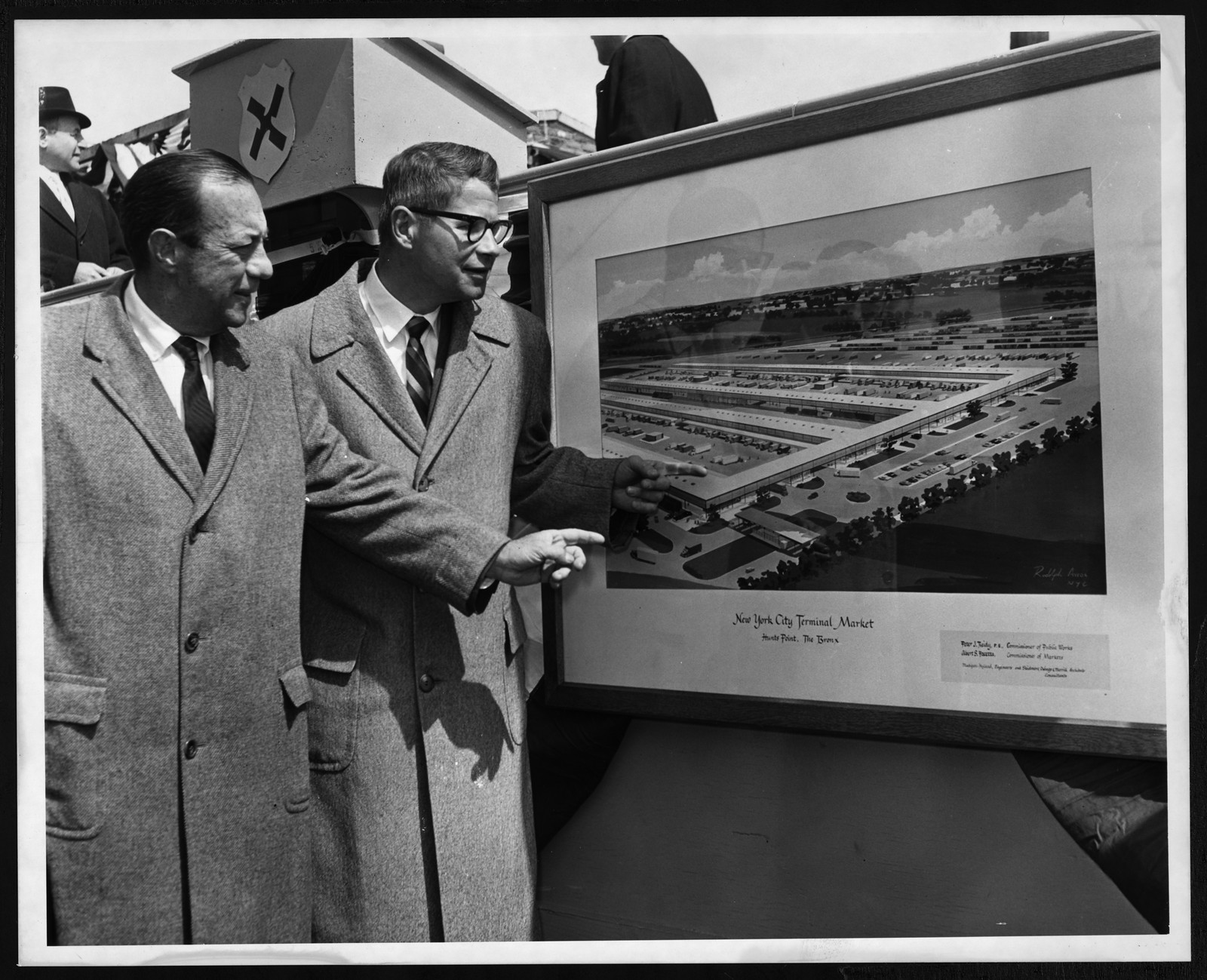 Two men viewing a rendering of the New York City Terminal Market, Hunts Point, The Bronx — historic image